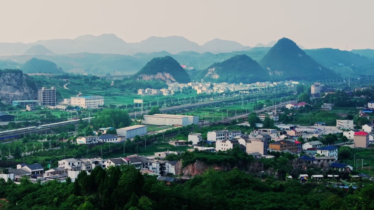 贵州安顺平坝喀斯特地貌城市高铁列车航拍
