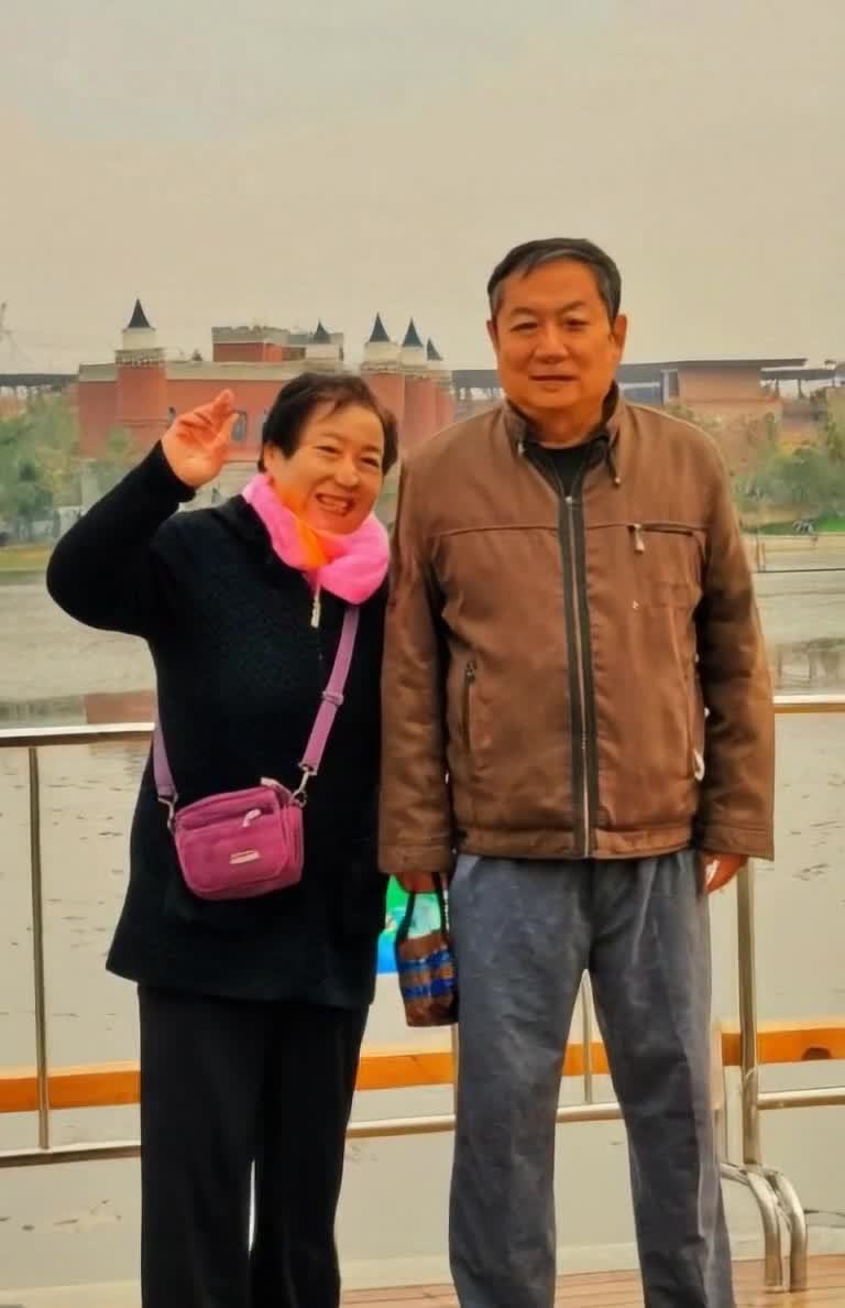 水边建筑背景下两位成年人的合影