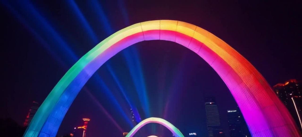 镜头从正前方开始，平稳向前推进一个彩虹形的灯光拱门