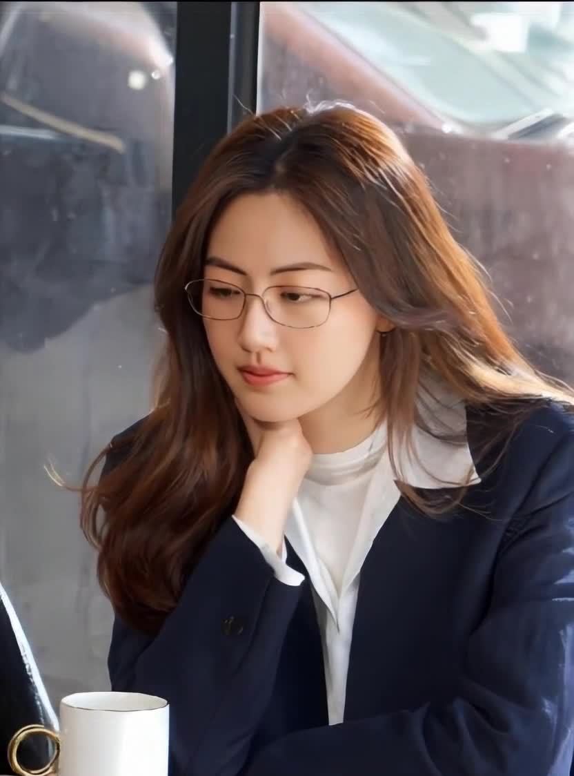 沉思的眼镜女士与咖啡杯