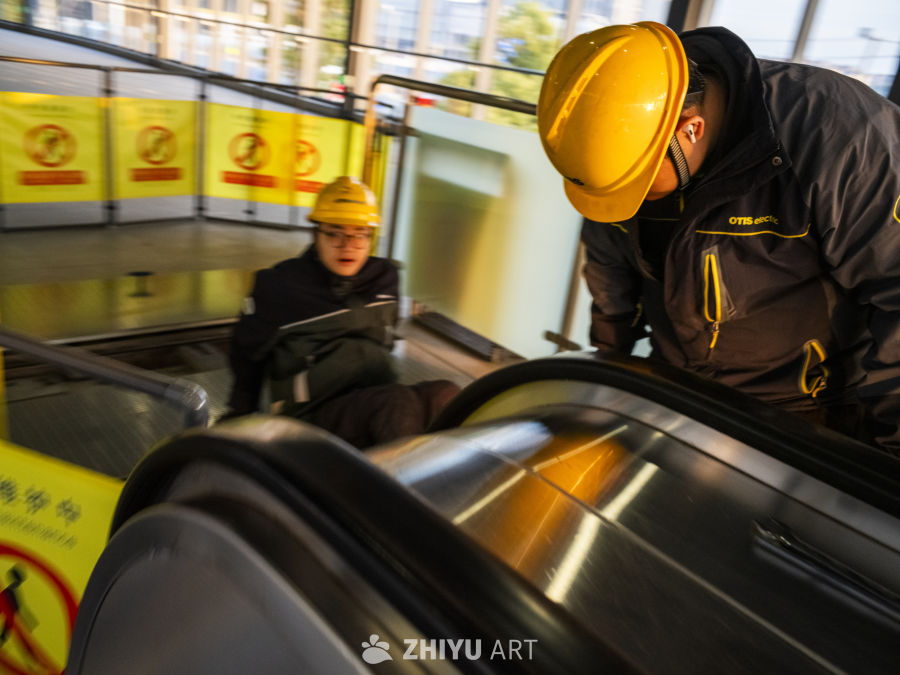 工人检查扶梯安全