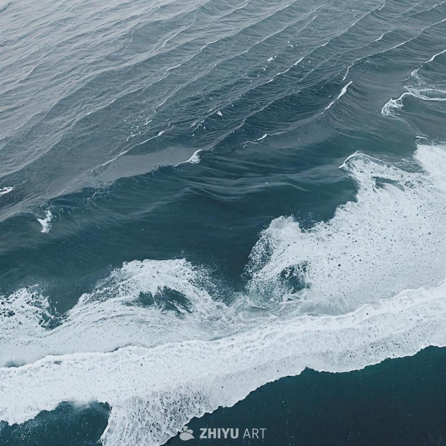 一个高角度拍摄的广阔水域的画面，可能是海洋，海浪拍