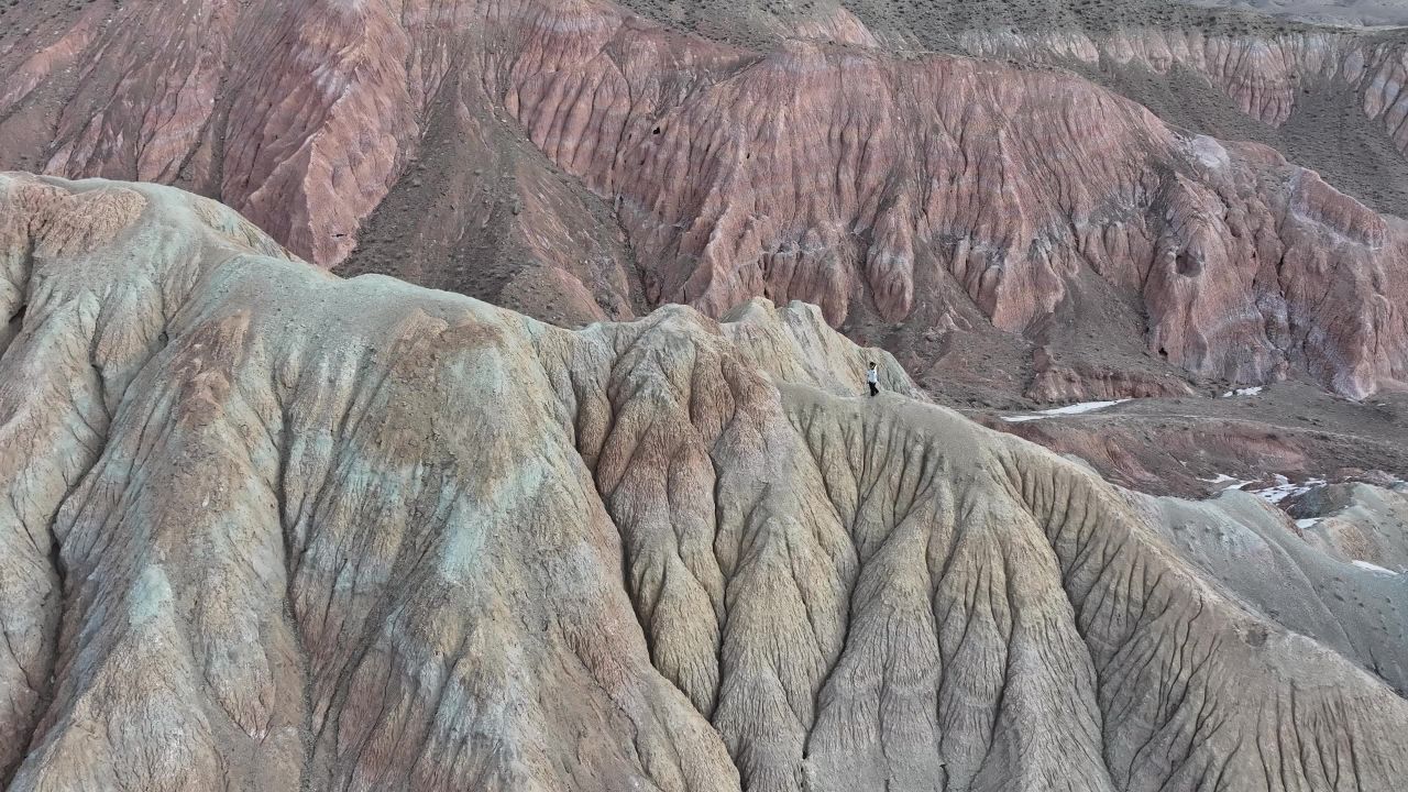 丹霞地貌人爬山往上走航拍