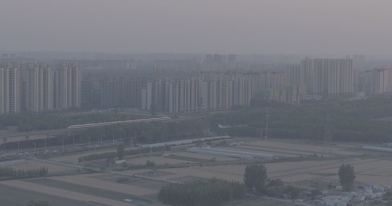 晨雾中的城市与农田