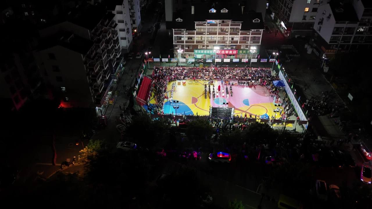 夜间篮球场航拍：人群狂欢夜