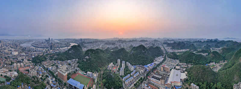广西柳州城市清晨日出航拍全景图 