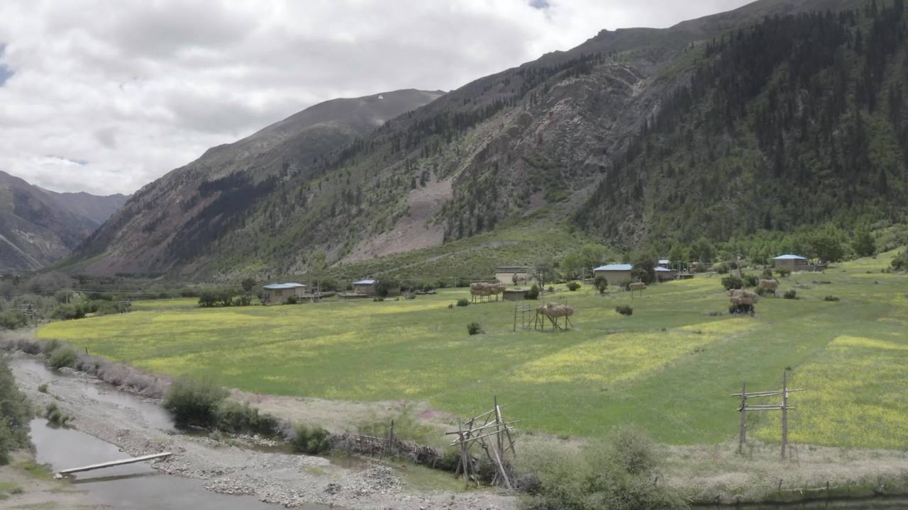 高山绿谷中蜿蜒河流与村落