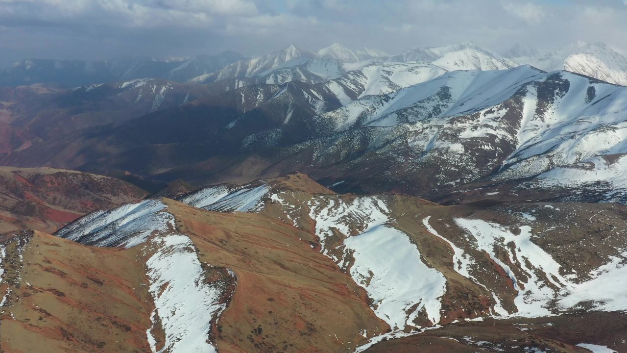 航拍风雪中的西藏洛隆县雪山风光