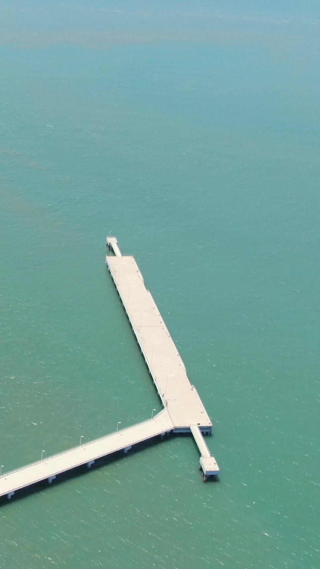 航拍蓝色海边礁石海浪